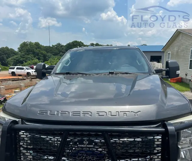 A Ford Super Duty in a Byron yard with its replacement windshield fitted