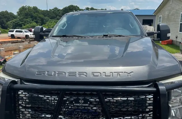 A Ford Super Duty pickup photographed head on with its newly fitted windshield