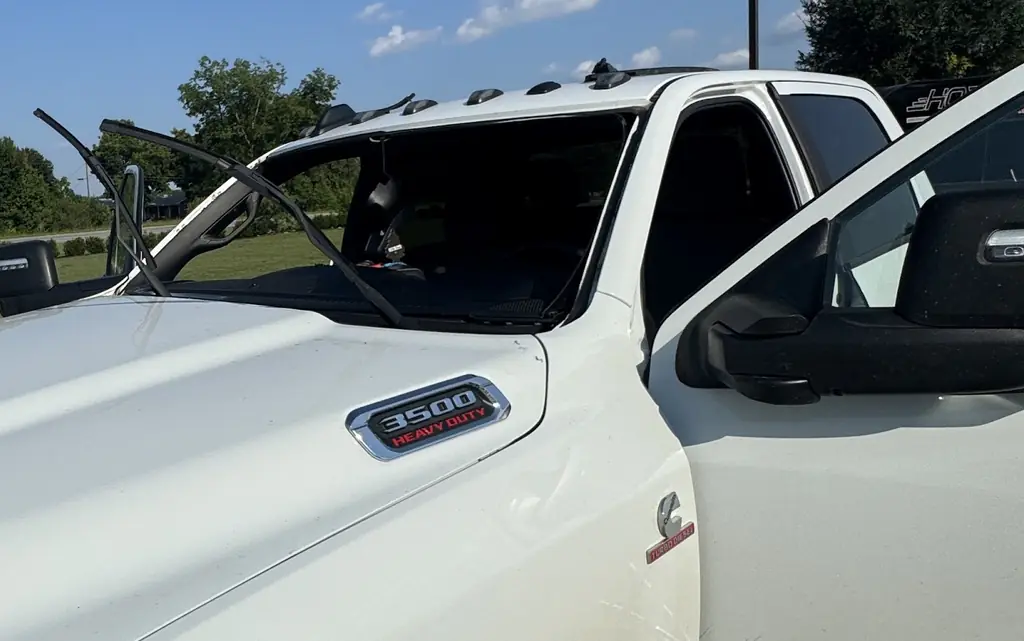 The empty windshield aperture of a Ram 3500 with the wipers standing upright